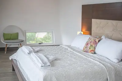 a bedroom with a large white bed with a window at Luxury Villa #13 De Los Monos with Jacuzzi in Playa Hermosa