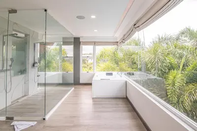 a bathroom with a walk in shower and a sink at Luxury Villa #13 De Los Monos with Jacuzzi in Playa Hermosa