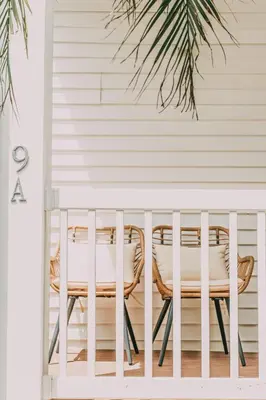 a porch with two chairs and a table at Azul Hotel & Retreat in Playa Azul