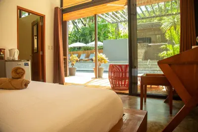 a bedroom with a bed and a view of a patio at The White Palms of Nosara in Nosara