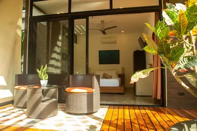 a room with a bedroom with a bed and a table at The White Palms of Nosara in Nosara