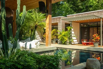 a house with a swimming pool with plants at The White Palms of Nosara in Nosara