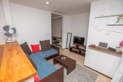 a living room with a couch and a tv at Casa Manta - Santa Teresa in Santa Teresa Beach