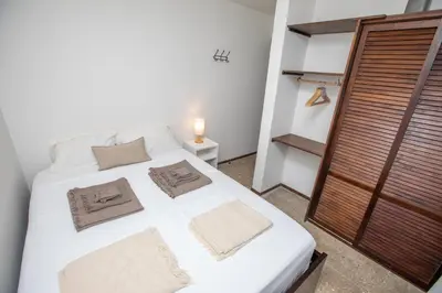a white bed with two pillows on it in a room at Casa Manta - Santa Teresa in Santa Teresa Beach
