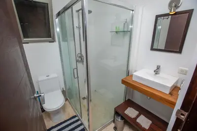 a bathroom with a shower and a toilet and a sink at Casa Manta - Santa Teresa in Santa Teresa Beach