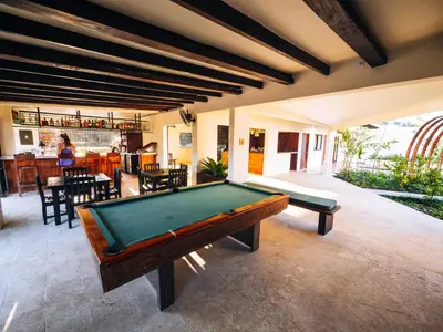 a pool table in a room with a bar at ONDA - Playa Grande - Adults Only in Playa Grande
