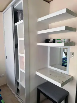 a walk in closet with a mirror and a stool at Senderos Apartment, Self Check- in, Airport SJO 5 MIN in Santiago Este