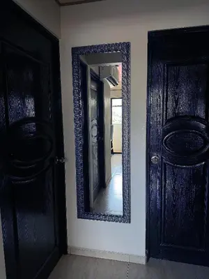 a mirror on a wall next to two doors at Senderos Apartment, Self Check- in, Airport SJO 5 MIN in Santiago Este