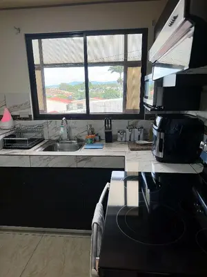 a kitchen with a sink and a window in it at Senderos Apartment, Self Check- in, Airport SJO 5 MIN in Santiago Este
