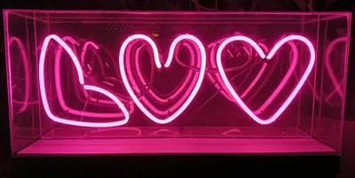 a neon sign that says love with two hearts at WET hotel - Adults Only in Tamarindo