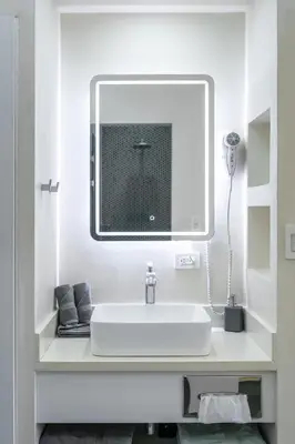 a bathroom with a sink and a mirror at WET hotel - Adults Only in Tamarindo