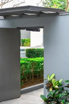 an open entrance to a building with plants at WET hotel - Adults Only in Tamarindo