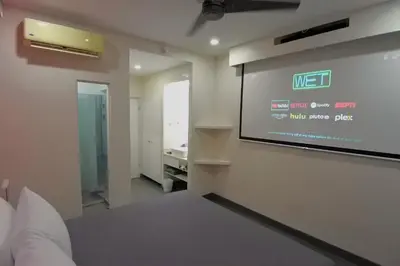 a room with a projection screen on the wall at WET hotel - Adults Only in Tamarindo