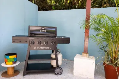 a barbecue grill with a laptop on top of it at 4BR Villa MotMot in w exclusive pool Wifi Ac in Quepos