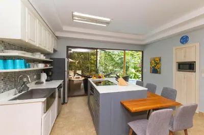 a kitchen with a sink and a counter top at Rainforest Gem Aracari Villa with Private Pool in Quepos