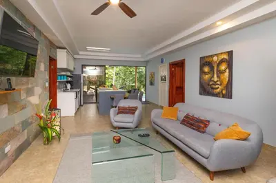 a living room with a couch and a table at Rainforest Gem Aracari Villa with Private Pool in Quepos