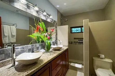 a bathroom with two sinks and a toilet at Rainforest Gem Aracari Villa with Private Pool in Quepos