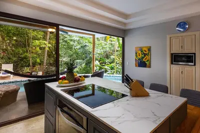 a kitchen with a island with a counter top at Rainforest Gem Aracari Villa with Private Pool in Quepos