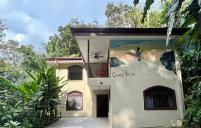 a house with a painting on the side of it at Renovated Casa Heron 3BR Private Pool near MA in Quepos