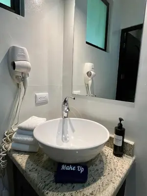 a bathroom with a sink and a mirror at Renovated Casa Heron 3BR Private Pool near MA in Quepos