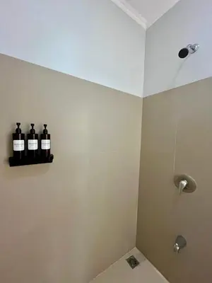 two bottles of wine sitting on a shelf in a bathroom at Renovated Casa Heron 3BR Private Pool near MA in Quepos