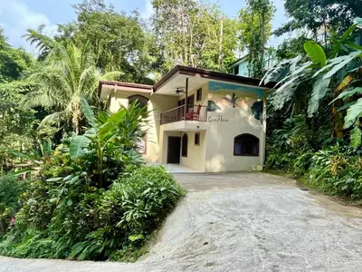 a house with a driveway in front of it at Renovated Casa Heron 3BR Private Pool near MA in Quepos