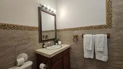 a bathroom with a sink and a mirror at Casa Macaw Jungle Cabin w Private Pool AC in Quepos