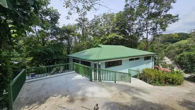 a small white building with a green roof at Casa Macaw Jungle Cabin w Private Pool AC in Quepos