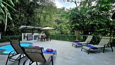 a patio with chairs and a swimming pool with trees at Casa Macaw Jungle Cabin w Private Pool AC in Quepos