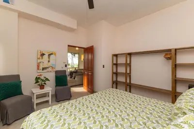 a bedroom with a bed and a living room at Exclusive Villa Tanager Ocean View w AC Private pool terrace in Quepos
