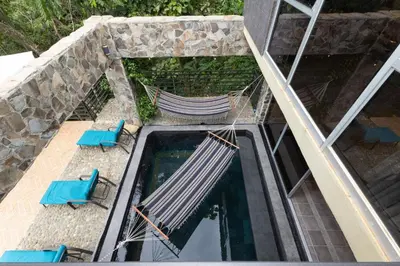an aerial view of two chairs and a swimming pool at Exclusive Villa Tanager Ocean View w AC Private pool terrace in Quepos