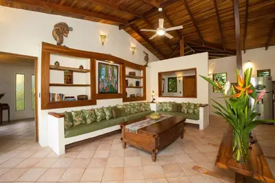 a living room with a couch and a coffee table at Toucan Villa Family home w Private Pool Garden in Quepos
