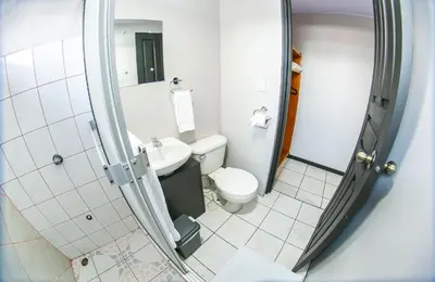 a small bathroom with a toilet and a sink at Hotel La Vid La Fortuna in Fortuna