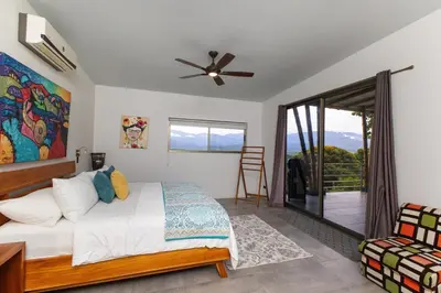 a bedroom with a bed and a ceiling fan at Secret Mountain Top 3BR Casa Colibrí private pool in Quepos