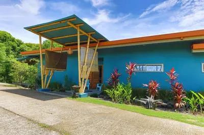 a blue house with a orange roof at Secret Mountain Top 3BR Casa Colibrí private pool in Quepos