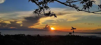 a sunset over the ocean with the sun setting at Río Celeste Nature View in Upala