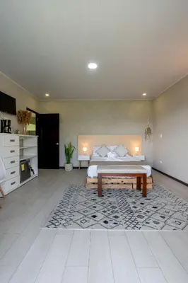 a large bedroom with a bed and a rug at House of Turri Suite Views Terrace & Jacuzzi in Verbena Norte