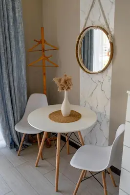 a white table and chairs in a room with a mirror at House of Turri Suite Views Terrace & Jacuzzi in Verbena Norte