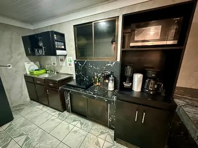 a kitchen with a sink and a counter top at Caribbean View House in Tortuguero