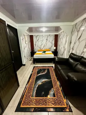 a living room with a couch and a bed at Caribbean View House in Tortuguero