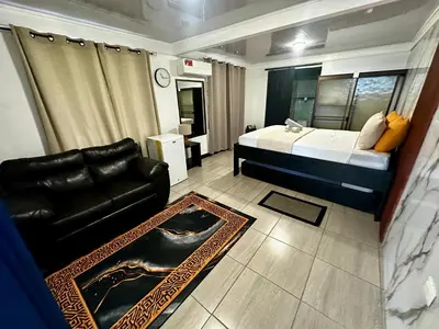 a bedroom with a bed and a couch in a room at Caribbean View House in Tortuguero