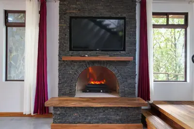 a fireplace with a television on top of it at Cougar Monteverde in Monteverde Costa Rica