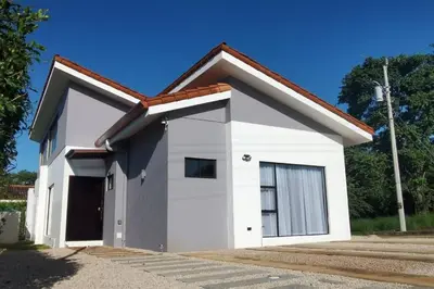 a small white garage with a large door at Casa Coral Tamarindo in Guatemala