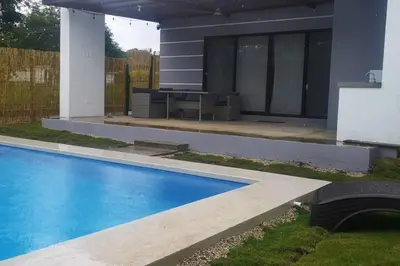a swimming pool in front of a house at Casa Coral Tamarindo in Guatemala