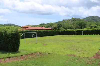 a field with two soccer goals in the grass at Casa Coral Tamarindo in Guatemala