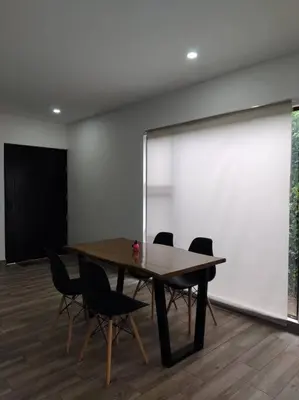 a conference room with a table and chairs and a screen at Casa Coral Tamarindo in Guatemala
