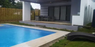 a swimming pool in front of a house at Casa Coral Tamarindo in Guatemala