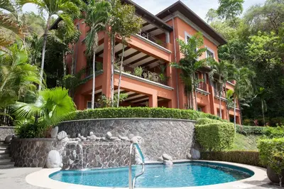a resort with a swimming pool in front of a building at Montebello 2C 3 bdr Ocean View in Los Suenos in Herradura