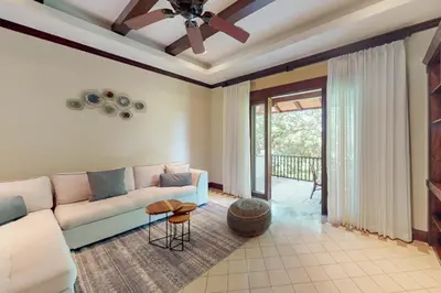 a living room with a couch and a ceiling fan at Pinilla Flor de Malinche 15 in Tamarindo