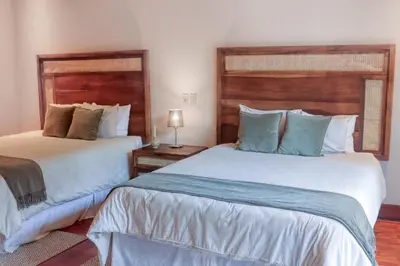 two beds in a room with two beds sidx sidx sidx sidx sidx at Pinilla Flor de Malinche 15 in Tamarindo